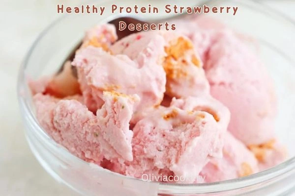 A close-up of a bowl of strawberry dessert. This dessert is high in protein, has a creamy pink texture, and has crumbly toppings.