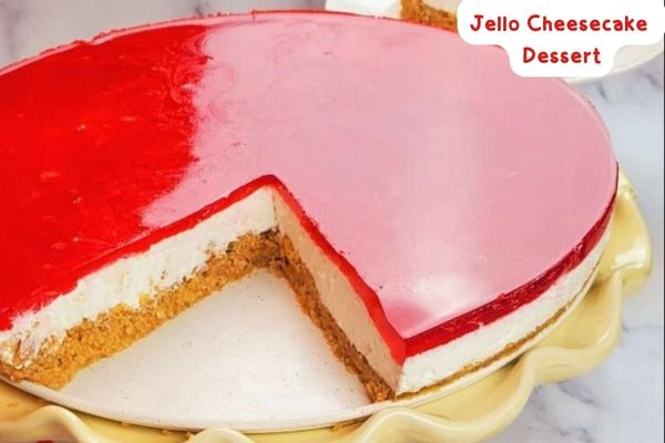 A vibrant and creamy dessert shaped like a cheesecake but sliced up and ornamented by many layers of gelatin above a creamy cheese base.