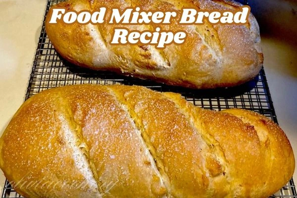 A food mixer with ingredients for a bread recipe, showcasing flour, yeast, and water in a mixing bowl.