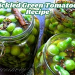 Three jars depicting bright pickled green tomatoes, garnishing spices, and a cinnamon stick, thus presenting freshly prepared tangy pickles.