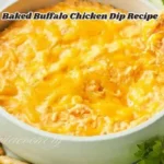 A deliciously baked buffalo chicken dip served with toasted bread slices, garnished with green onions and bubbling cheese on top.