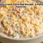 A bowl of creamy crack corn dip, tortilla chips, and fresh herbs are ready to be served as a delicious appetizer.